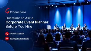 Corporate event planning banner featuring a blue-lit conference stage, panel discussion, business audience, and the title “Questions to Ask a Corporate Event Planner Before You Hire.”